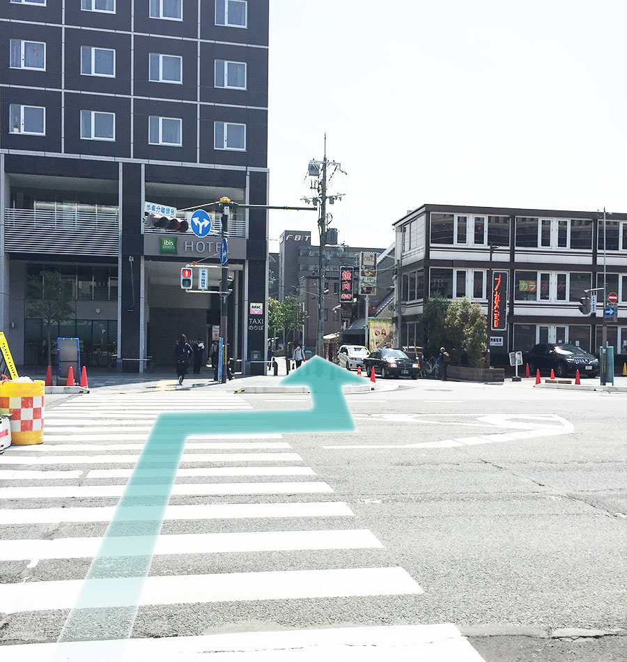 Cross the crosswalk facing back to Kyoto Station.